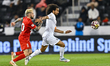 Akram Hassan of Al Sadd FC and Federico Nicolas Cartabia of Shabab Al Ahli Dubai FC are se...