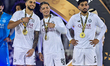 Al Sadd SC players celebrate on the podium after winning the Qatar-UAE Super Shield final...