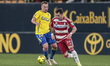 Alex Sola of Granada CF competes for the ball with Javi Ontiveros of Cadiz CF during the L...