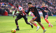 Morgan Gibbs-White of Nottingham Forest is under pressure from Michael Kayode of Brentford...
