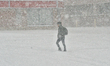People walk as a massive snowstorm hits Toronto, Ontario, Canada, on January 25, 2026. Env...