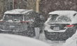 A person clears snow from a vehicle as a massive snowstorm hits in Toronto, Ontario, Canad...
