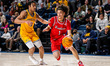Xavier Abreu of the Northeastern Huskies drives the ball during an NCAA men's basketball g...