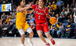 Xavier Abreu of the Northeastern Huskies drives the ball during an NCAA men's basketball g...