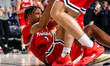 Ryan Williams (2) of the Northeastern Huskies is helped up during an NCAA men's basketball...