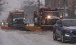 A snowplow makes its way along the road during a snowstorm in Toronto, Ontario, Canada, on...