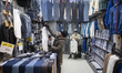 Iranian traders adjust dresses in their shop at the Grand Bazaar in southern Tehran, Iran,...