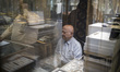An Iranian trader sits in his gold shop at the Grand Bazaar in southern Tehran, Iran, on J...