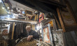 An Iranian trader works in his carpet shop at the Grand Bazaar in southern Tehran, Iran, o...