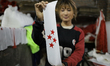 A Nepali worker dries the freshly screen-printed flags of a political party in Kathmandu V...