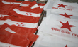 Freshly screen-printed flags of a political party are left out to dry in a workshop in Kat...