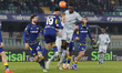 Tobias Slotsager of Hellas Verona FC battles for the ball with Lennon Miller of Udinese FC...