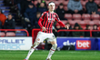 Evan Weir of Walsall FC wears a bandage on his head following a knock during the Sky Bet L...