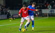 Ryan Graydon of Salford City FC is under pressure from Tom Pearce of Chesterfield FC durin...