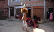 Nepalese impersonate Hindu God Madhav Narayan, offering holy water to devotees during the...