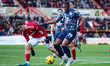 Darren Oldaker of Swindon Town stops Jovan Malcom of Barrow AFC during the Sky Bet League...