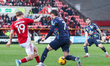 Joe Snowdon of Swindon Town moves to intercept the attacking run by Ben Jackson of Barrow...