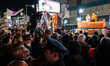 Supporters and demonstrators gather near a street speech held by the Sanseito party in Tok...