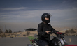 An Iranian female motorcyclist wears a helmet and rides a motorcycle during a training ses...