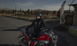 An Iranian female motorcyclist wears a helmet and poses for photographs with a motorcycle...