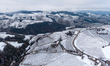 In Langhe, Piedmont, Italy, on February 3, 2026, a panorama of snow-covered vineyards appe...