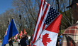 EDMONTON, CANADA - MAY 3: A participant holds a fabricated US/Canadian joined flag as Alb...