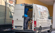 A Hermes delivery courier organizes parcels inside a transport van in Munich, Bavaria, Ger...