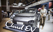 A sales promotion girl stands next to the EV car produced by Wuling during the 2026 Indone...