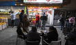 Iranian people shop for ice cream and fast food near a shopping center in downtown Tehran,...
