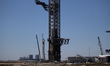 A Starship launch tower stands at the Starbase launch site at SpaceX's South Texas facilit...