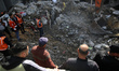Civil defence teams search for the bodies of the Salem family under the rubble of their ho...