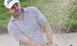 Richard Sterne of South Africa plays his third shot from the bunker on the 18th hole durin...