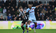 Lewis Hall of Newcastle United is challenged by Igor Thiago of Brentford during the Premie...