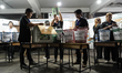 Thai electoral officials count ballots after the polls close in the general election and n...