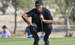Patrick Reed of the United States is in action during the fourth round of the Qatar Master...