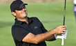 Patrick Reed of the United States is in action during the fourth round of the Qatar Master...