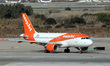 An easyJet Airbus A319-111 is on the runway for takeoff from Barcelona-El Prat Airport in...