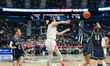Kayleigh Heckel #9 of the Connecticut Huskies looks to pass while being pressured by Anna...