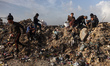 Palestinians search for items to salvage at a landfill in the Firas Market area of Gaza Ci...