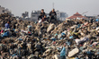 Palestinians search for items to salvage at a landfill in the Firas Market area of Gaza Ci...