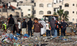 A Palestinian boy searches for items to salvage at a landfill in the Firas Market area of...