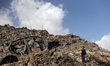 A Palestinian boy searches for items to salvage at a landfill in the Firas Market area of...