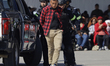 Police officers simulate an operation during an initial training ceremony for community po...