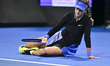 Anna Kalinskaya of Russia reacts after slipping during her quarterfinal match against Karo...