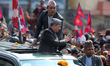 Former Nepali King Gyanendra Bir Bikram Shah greets his supporters as he exits Tribhuvan I...