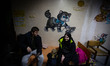 A couple with their young daughter stands in a hospital corridor in Sumy, Ukraine, after a...