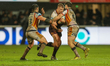 Harry Rushton is tackled by Toby Sexton and Benjamin Garcia during the BetFred Super Leagu...