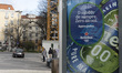 People walk by a Heineken banner in Lisbon, Portugal, on February 14, 2026. 