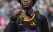 Sixteen-year-old Tito Odunaike shows off his medal after winning the Triple Jump during th...
