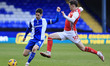 Tom Pett of Oldham Athletic Association Football Club tussles with Mark Helm of Fleetwood...